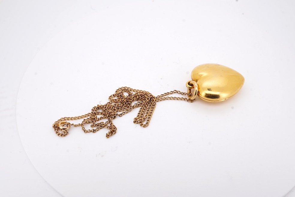 A modern embossed 9ct gold heart shaped locket, 21mm, on a similar 9ct gold rope twist chain, 46cm, together with one other yellow metal heart shaped locket, on a yellow metal chain, gross weight 14.5 grams. Condition -